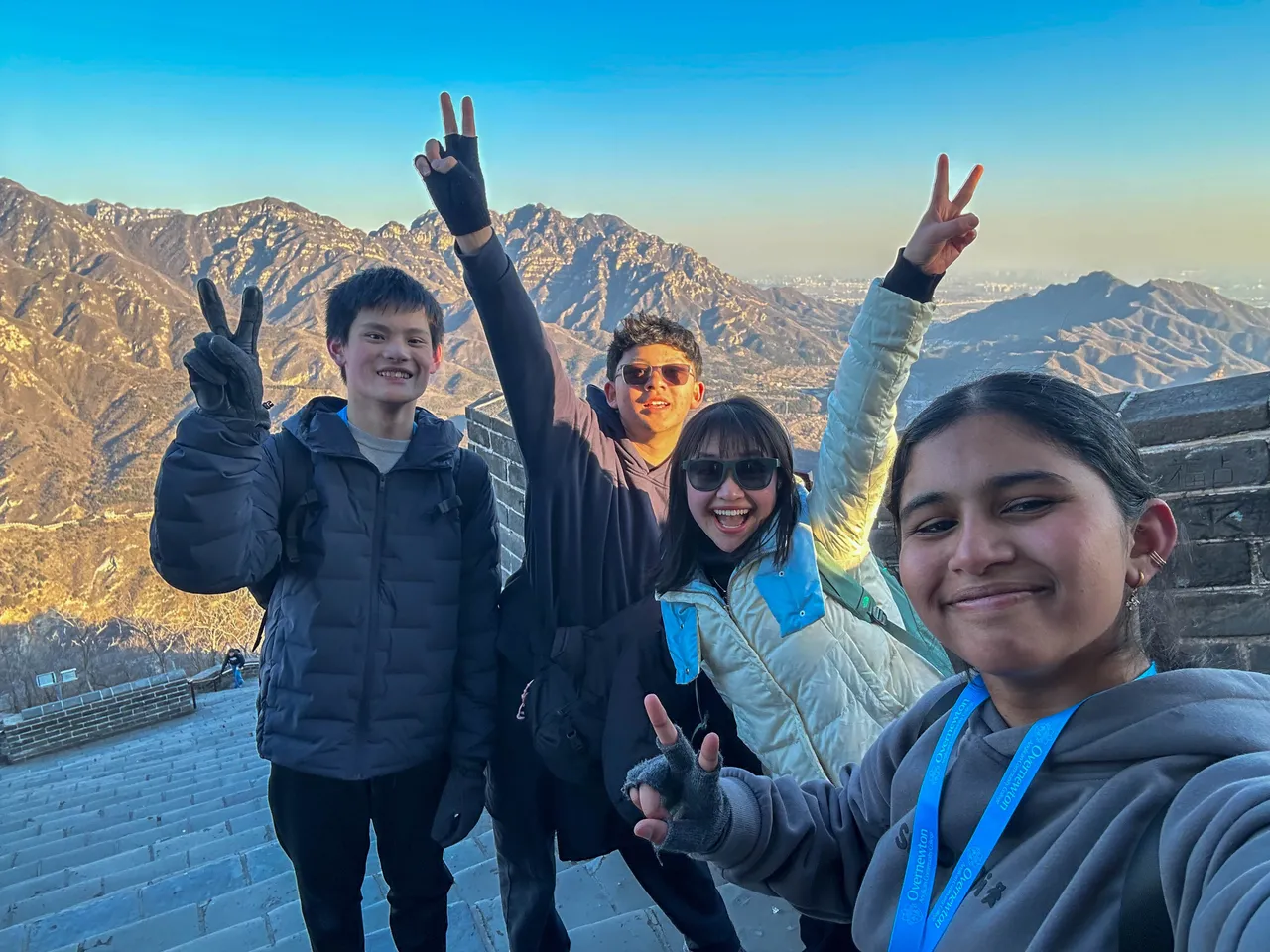 Middle and upper secondary school aged students and a staff member standing on the Great Wall of China during Overnewton’s 2025 China Tour.