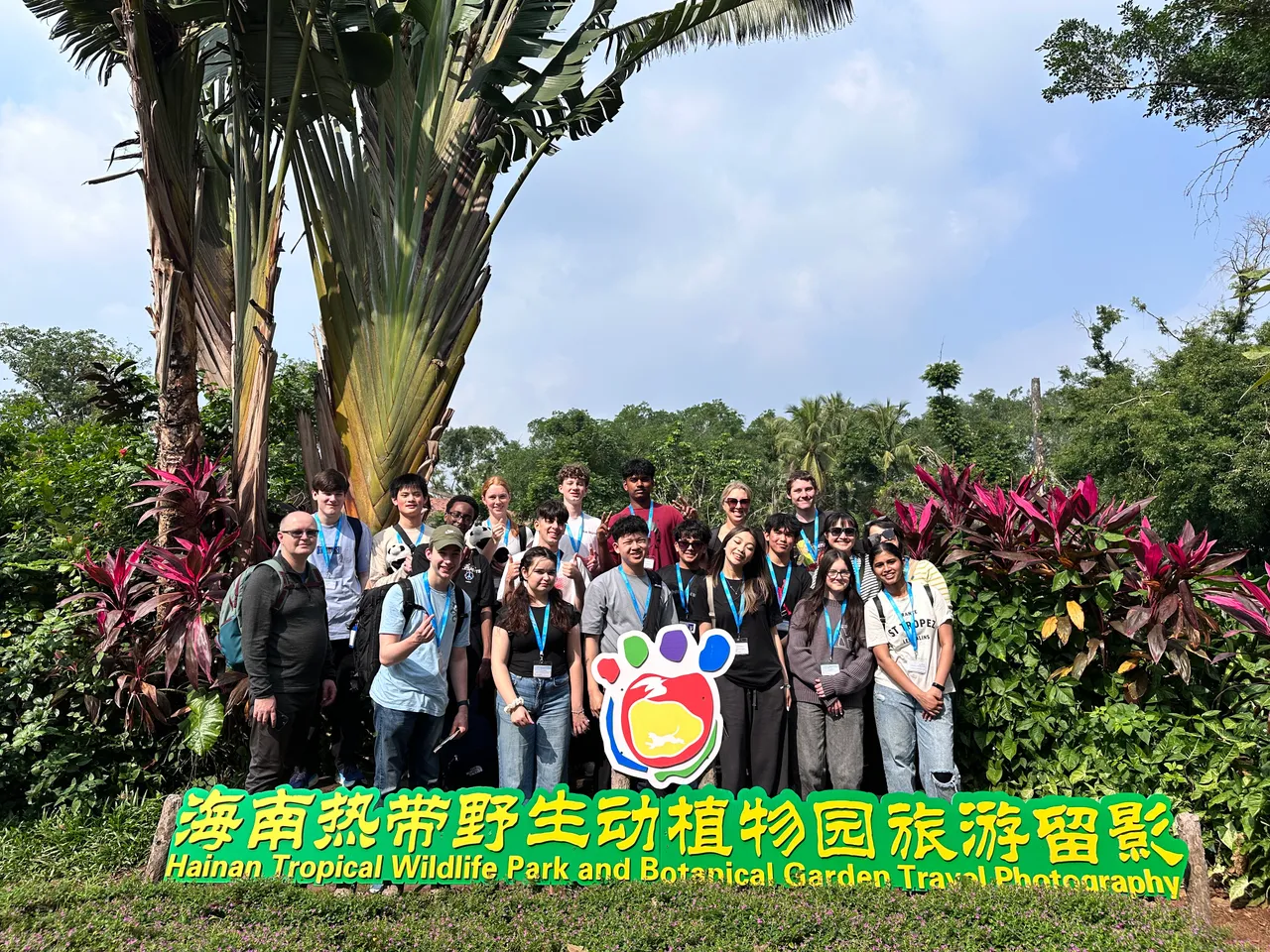 Students and staff gather behind a sign at the Hainan Tropical Wildlife Park and Botanical Gardens, as part of Overnewton's 2025 educational travel tour to China.