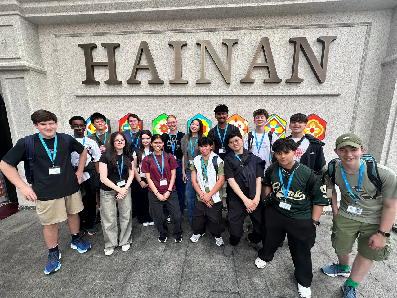 Photo of the entire group of middle and upper secondary school aged students standing in front of a large Hainan sign as part of Overnewton's 2025 educational travel tour to China.