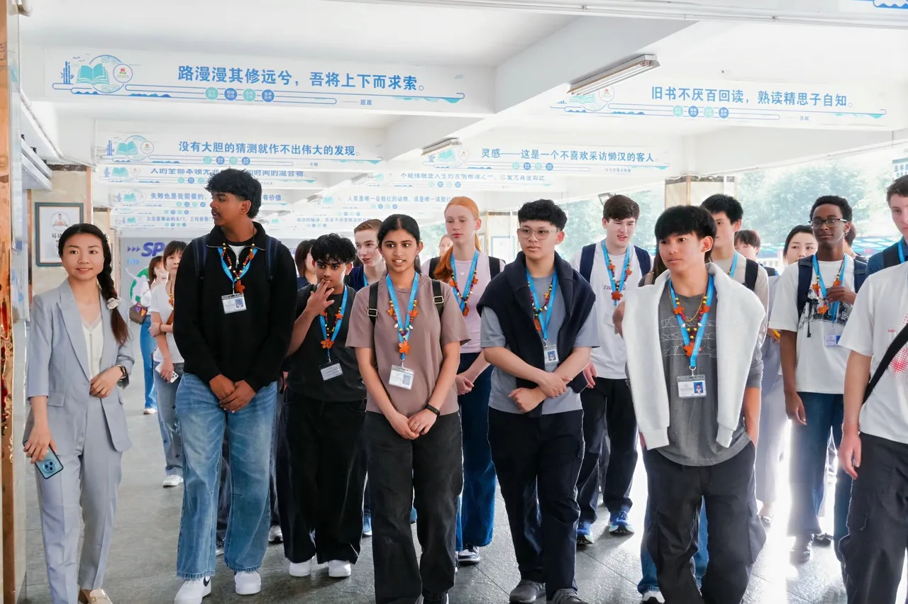 Middle and upper secondary school aged Overnewton students are led through the entryway of an international school visited on the College's 2025 China tour.