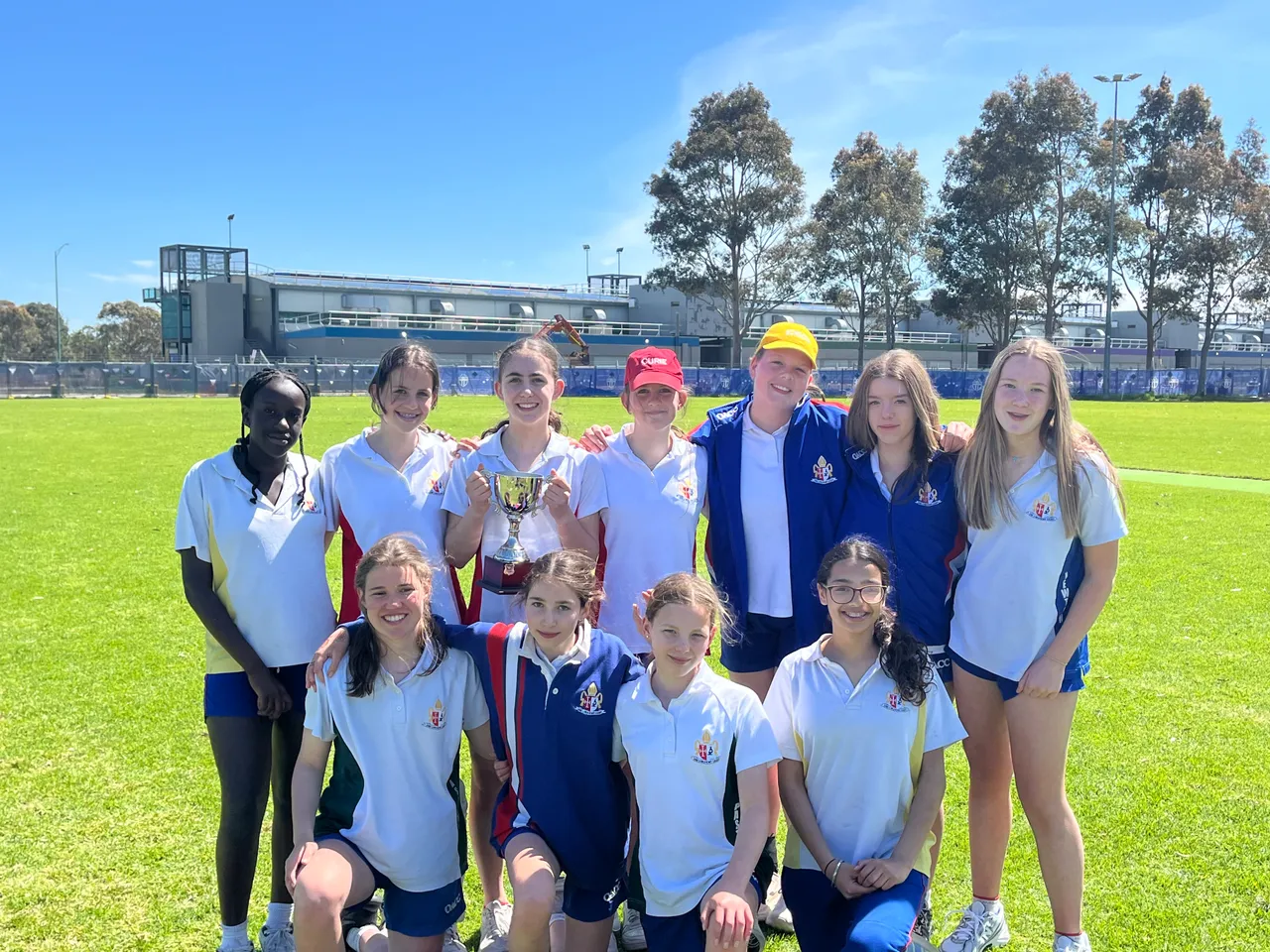 Overnewton Girls Cricket team gathers to proudly present their ACS Girls Cricket Gala Day championship trophy.