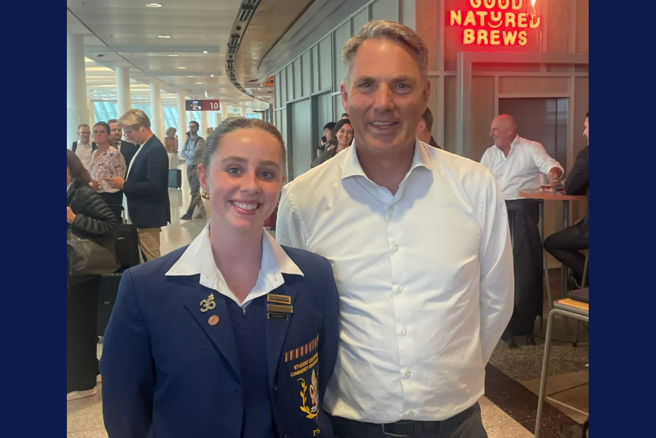 Upper secondary school aged student from Overnewton's Senior School on a visit to Canberra, photographed standing beside Australia's Deputy Prime Minister of the day.
