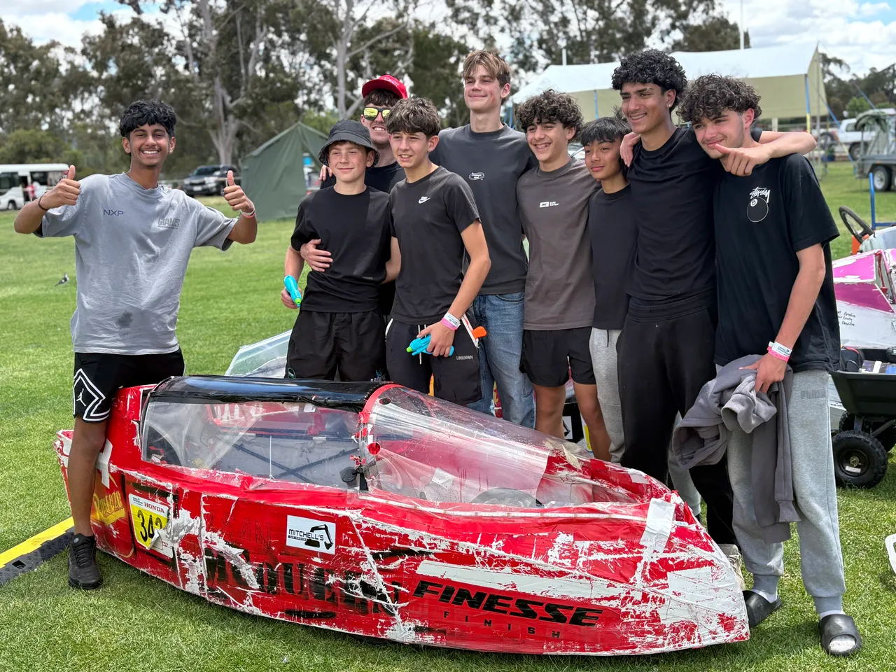 Group of eight Year 9 students standing proudly behind the vehicle they built to race at the Energy Breakthrough Challenge in Maryborough.