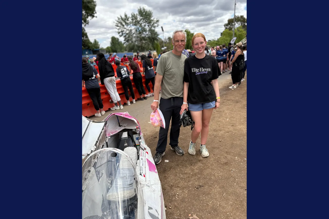 Year 9 student and her father standing proudly beside her team's competition vehicle at the Energy Breakthrough Challenge at Maryborough.