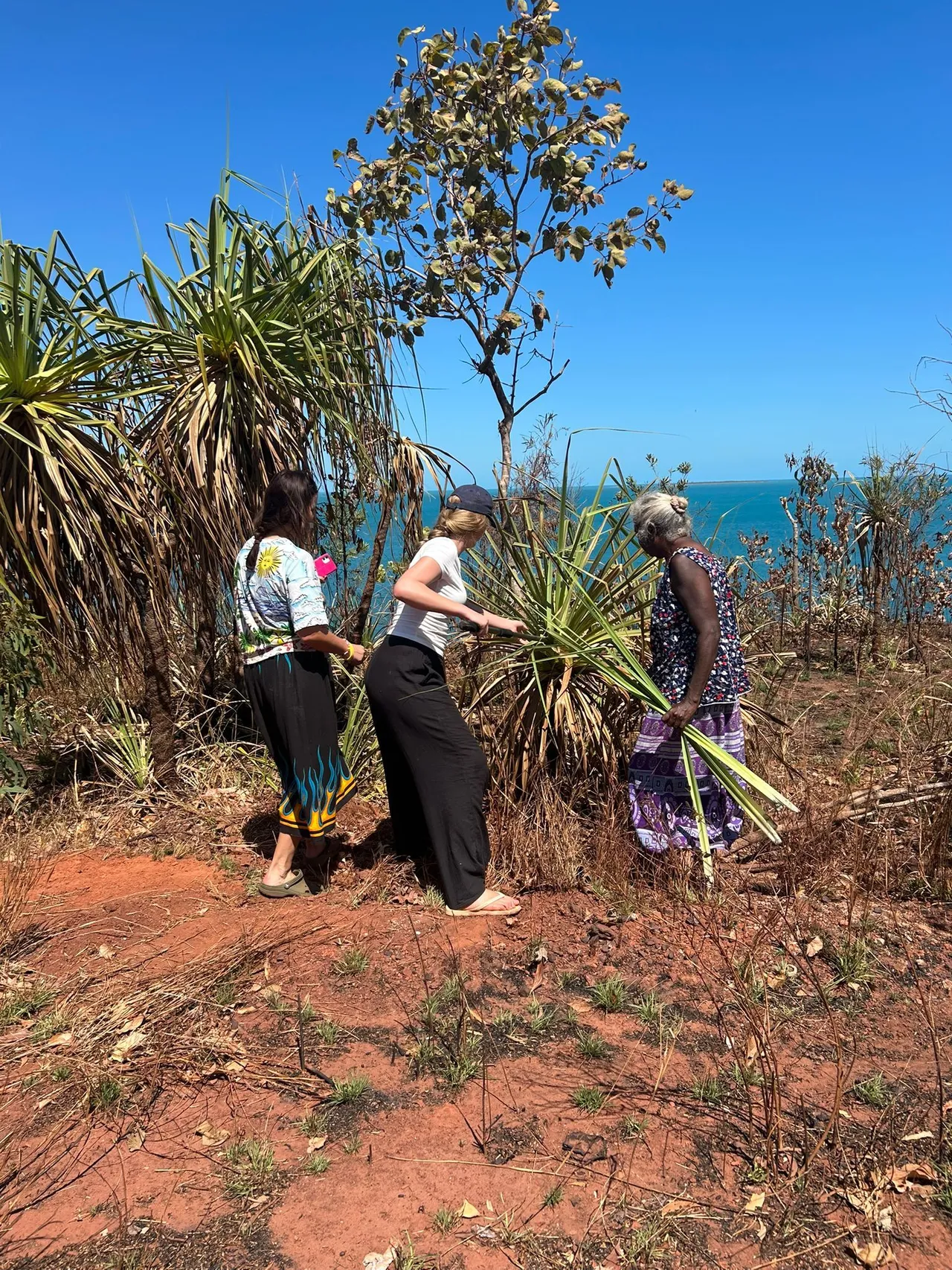 Upper secondary school aged student engaging in a Learning on Country experience with a local Indigenous elders at Elcho Island in the Northern Territory during Overnewton’s 2025 Galiwin’ku educational travel program.