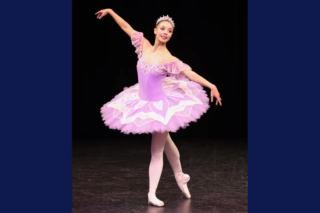 Class of 2025 upper secondary school aged student performing an elegant solo ballet on stage in a pink and white tutu.
