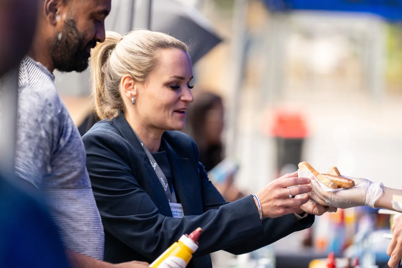 Members of the Overnewton community being served at the sausage sizzle as part of the inaugural Canowindra Parent Information Evening.