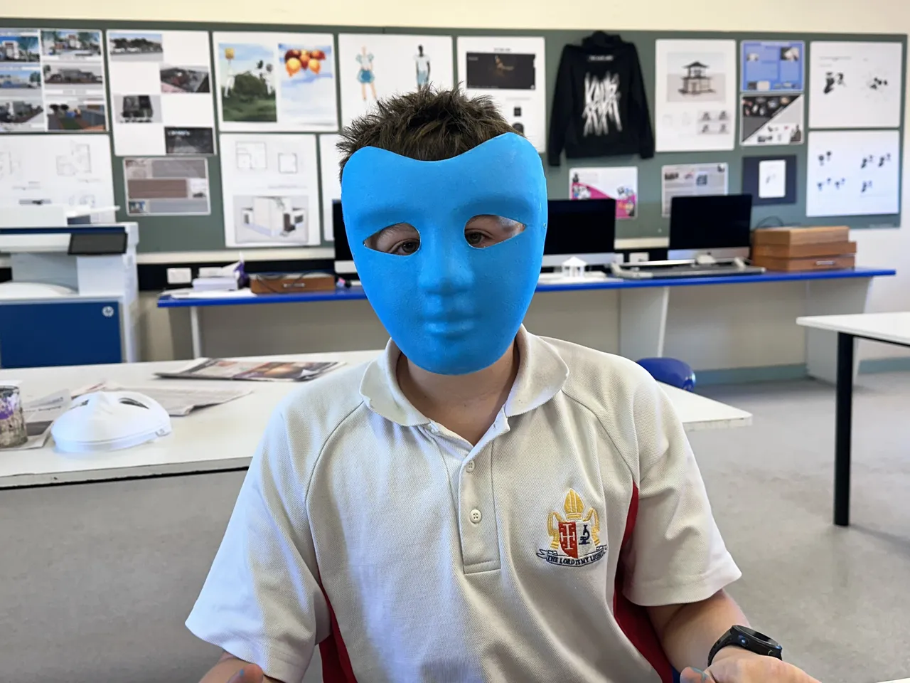 Secondary school-aged student from Middle School painting a mask during Overnewton’s 2025 Languages and Culture Week.