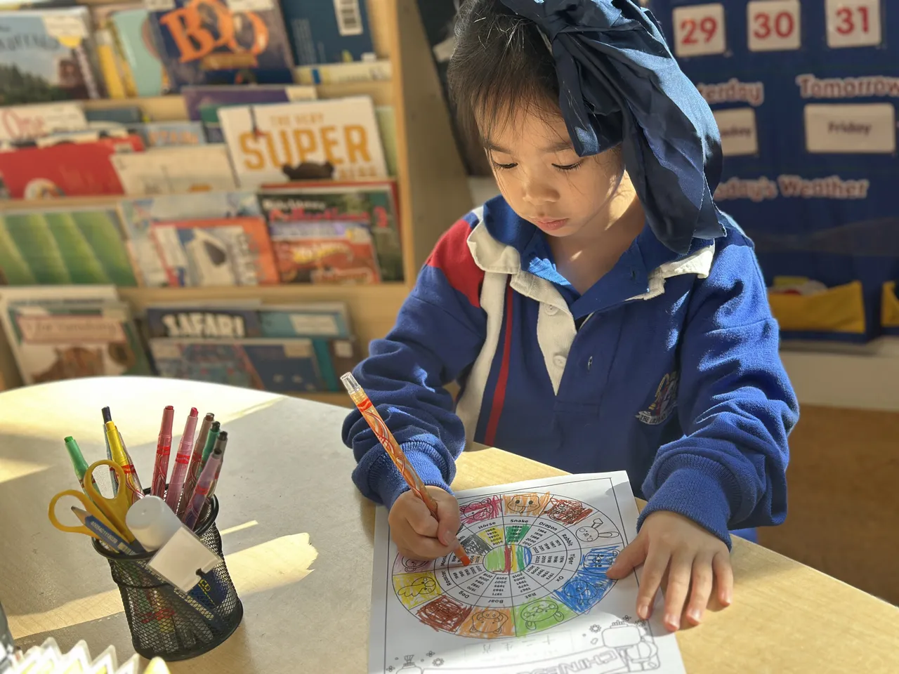 Lower primary school aged student from Overnewton Junior School colouring a Chinese zodiac design during Overnewton’s 2025 Languages and Culture Week.