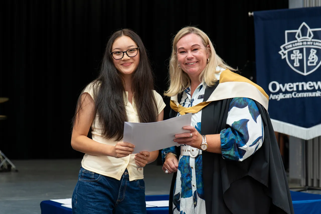 Class of 2025 student receiving a certificate from Principal Emily FitzSimons for achieving dux in a VCE subject at the Class of 2025 VCE Awards Assembly.