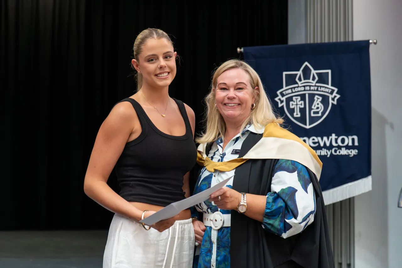 Class of 2025 student receiving a certificate from Principal Emily FitzSimons for achieving dux in a VCE subject at the Class of 2025 VCE Awards Assembly.