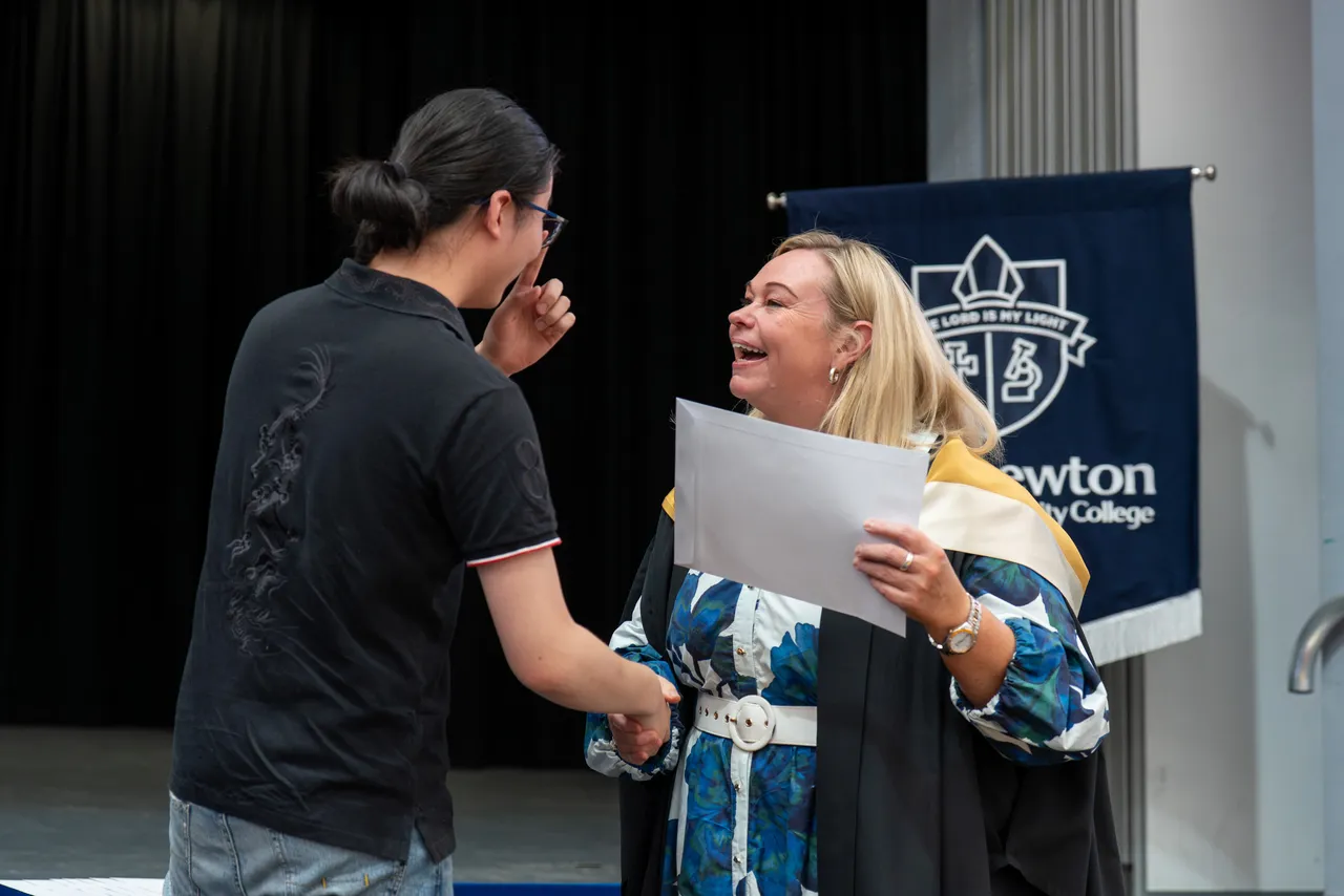 Class of 2025 College Dux Nathan Yuan receiving a certificate from Principal Emily FitzSimons for achieving dux in a VCE subject at the Class of 2025 VCE Awards Assembly.