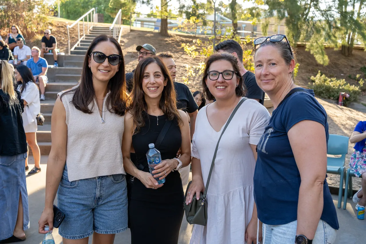 A group of happy parents relaxing during a hot summer evening, attending the inaugural Yirramboi Parent Information Evening held in the Middle School Outdoor Amphitheatre.
