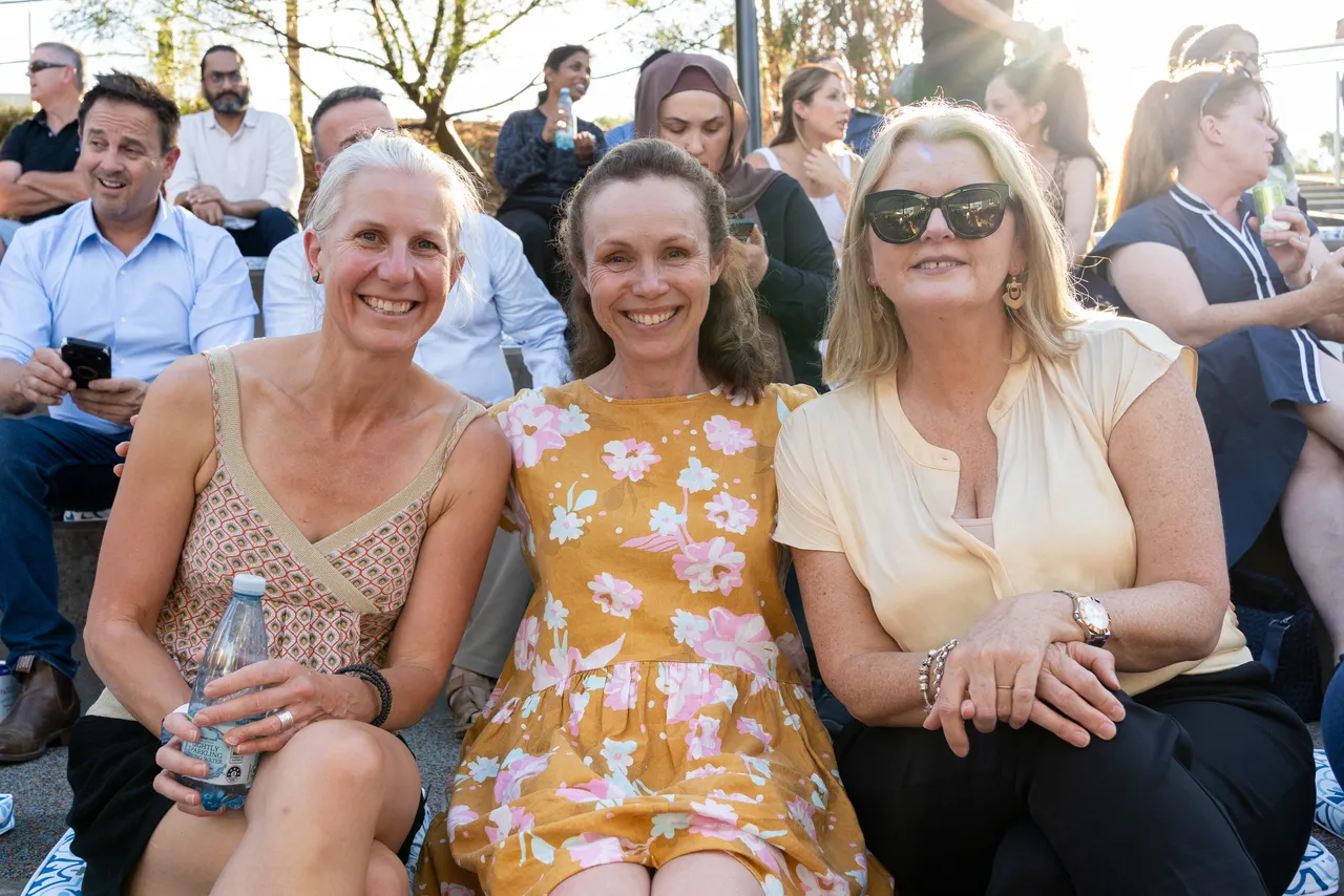 A group of happy parents relaxing during a hot summer evening, attending the inaugural Yirramboi Parent Information Evening held in the Middle School Outdoor Amphitheatre.