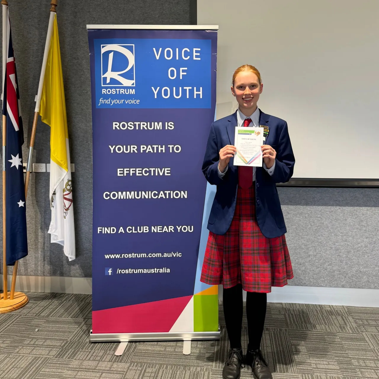 Middle secondary school aged student proudly holding a certificate after participating in the Rostrum Voice of Youth Public Speaking Competition, as part of Overnewton's Be Heard Co Curricular program.