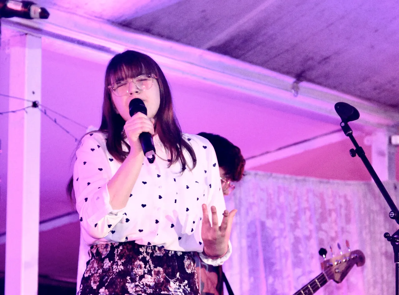 Middle secondary school aged student performing on stage as part of a rock band during 'Out of the Blue' at Overnewton’s annual Festival of Music, the signature event of the Encore Performing Arts Co Curricular program.