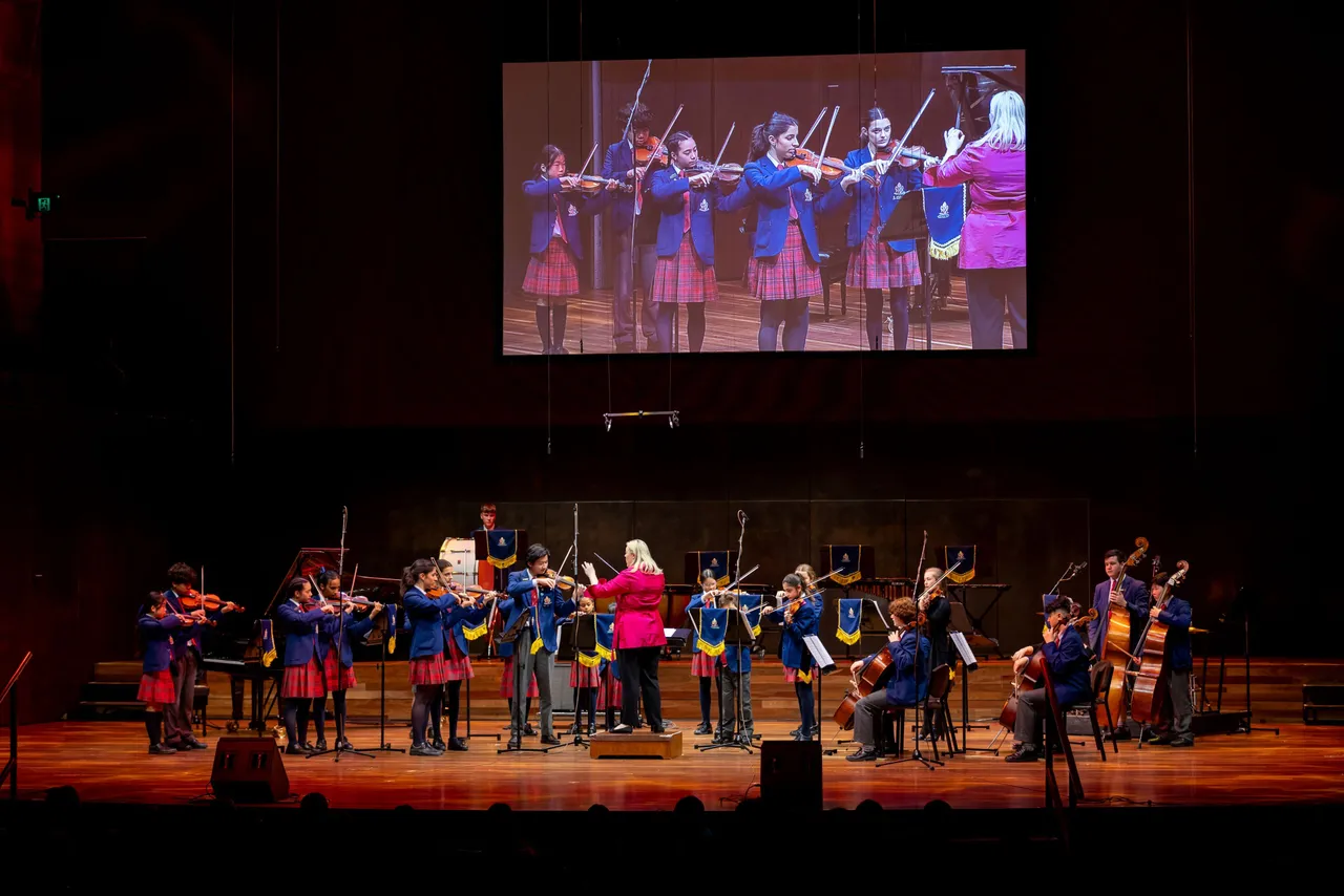 Group of upper primary and secondary school aged students performing as part of a string orchestra at Overnewton’s annual Presentation Night at Hamer Hall, showcasing the Encore Performing Arts Co Curricular program.