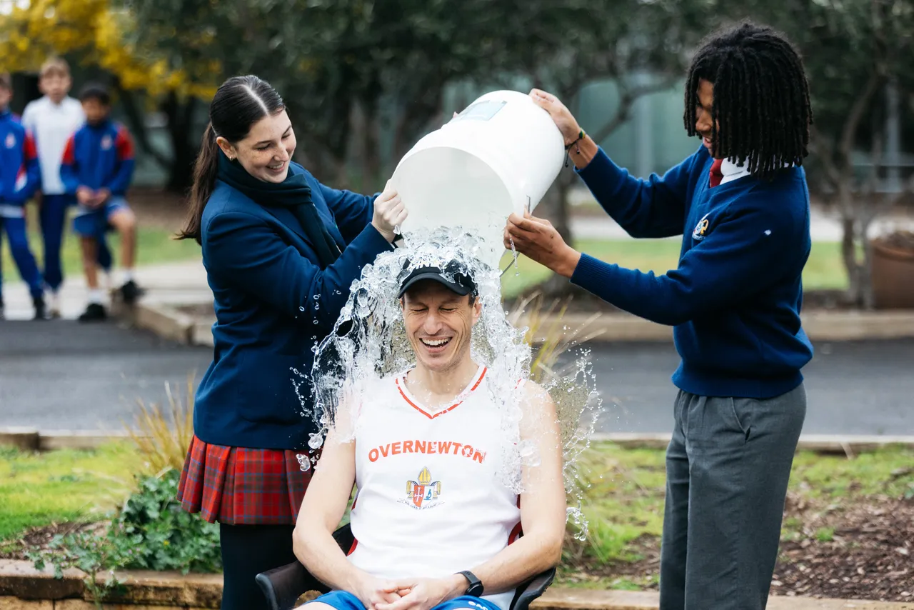 Senior secondary school aged students gleefully tipping buckets of ice over costumed Senior School teacher in support of the MND Big Freeze - part of Overnewton’s Synergy Co Curricular pillar promoting social justice and community action.