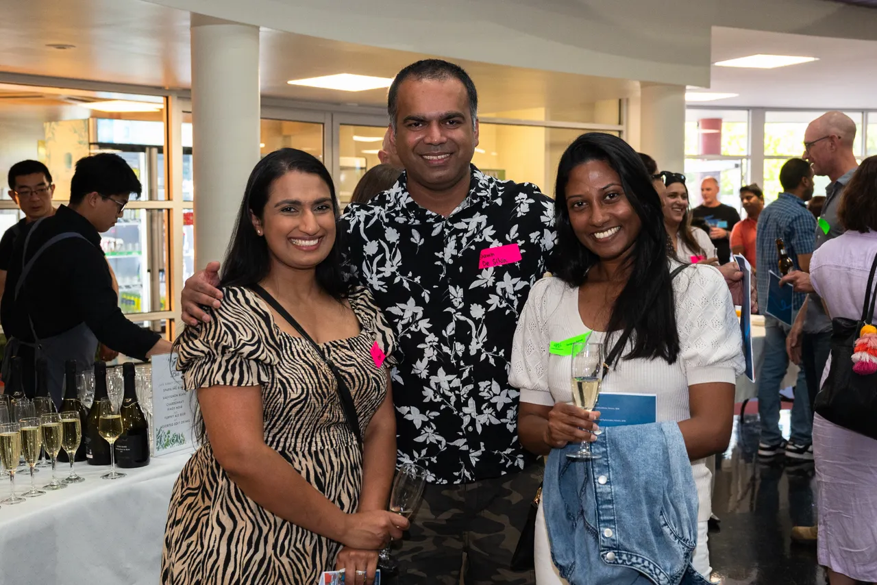 Happy parents interacting at an Overnewton parent function designed to help families connect and meet new members of the community.