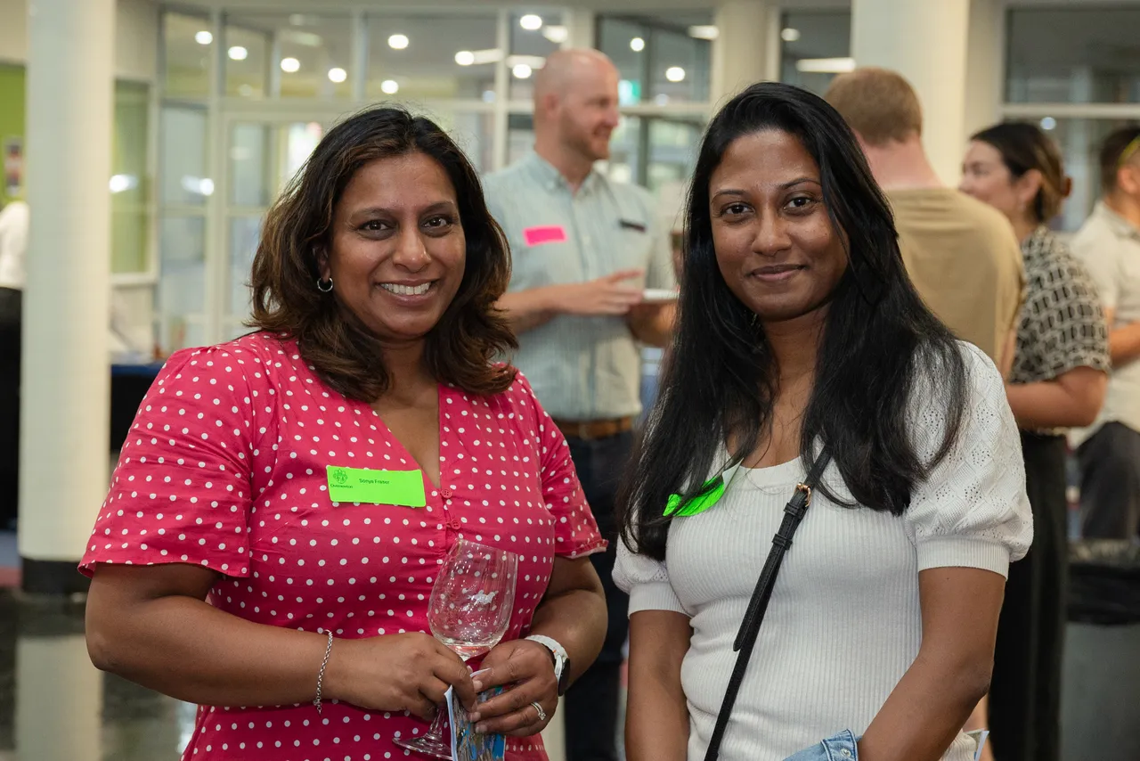 Happy parents interacting at an Overnewton parent function designed to help families connect and meet new members of the community.