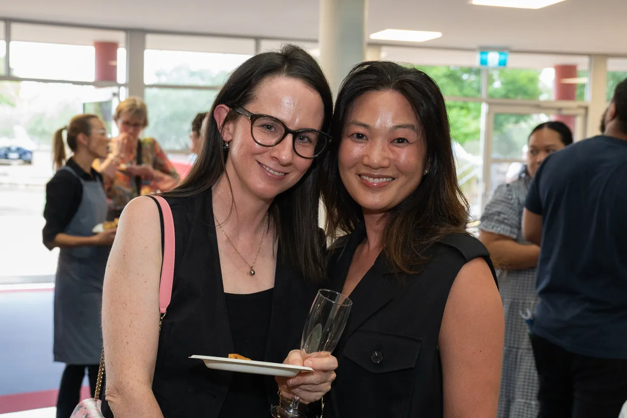 Happy parents interacting at an Overnewton parent function designed to help families connect and meet new members of the community.