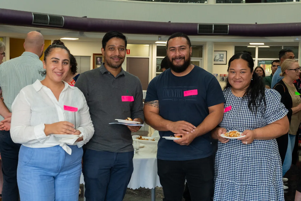 Group of happy parents interacting at an Overnewton parent function designed to help families connect and meet new members of the community.