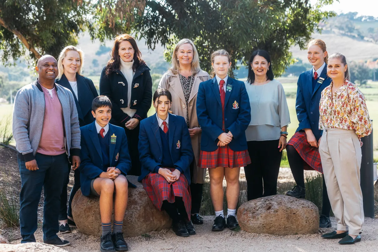 Group of students, parent volunteers, and Principal Emily FitzSimons posing together as members of the Overnewton sustainability team.
