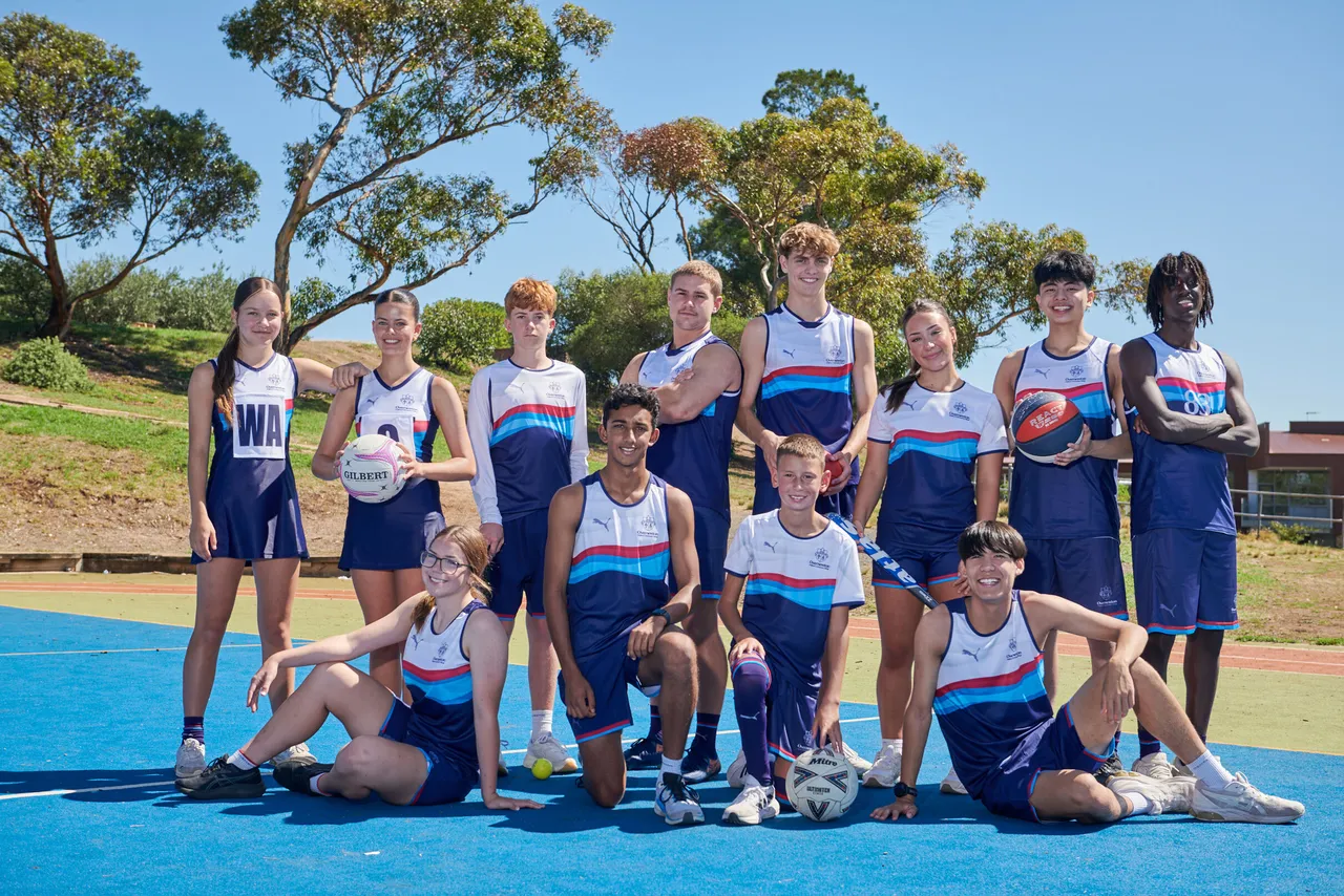 Middle and senior secondary school aged students wearing the Overnewton Competitive Sportswear range and holding matching sporting equipment.
