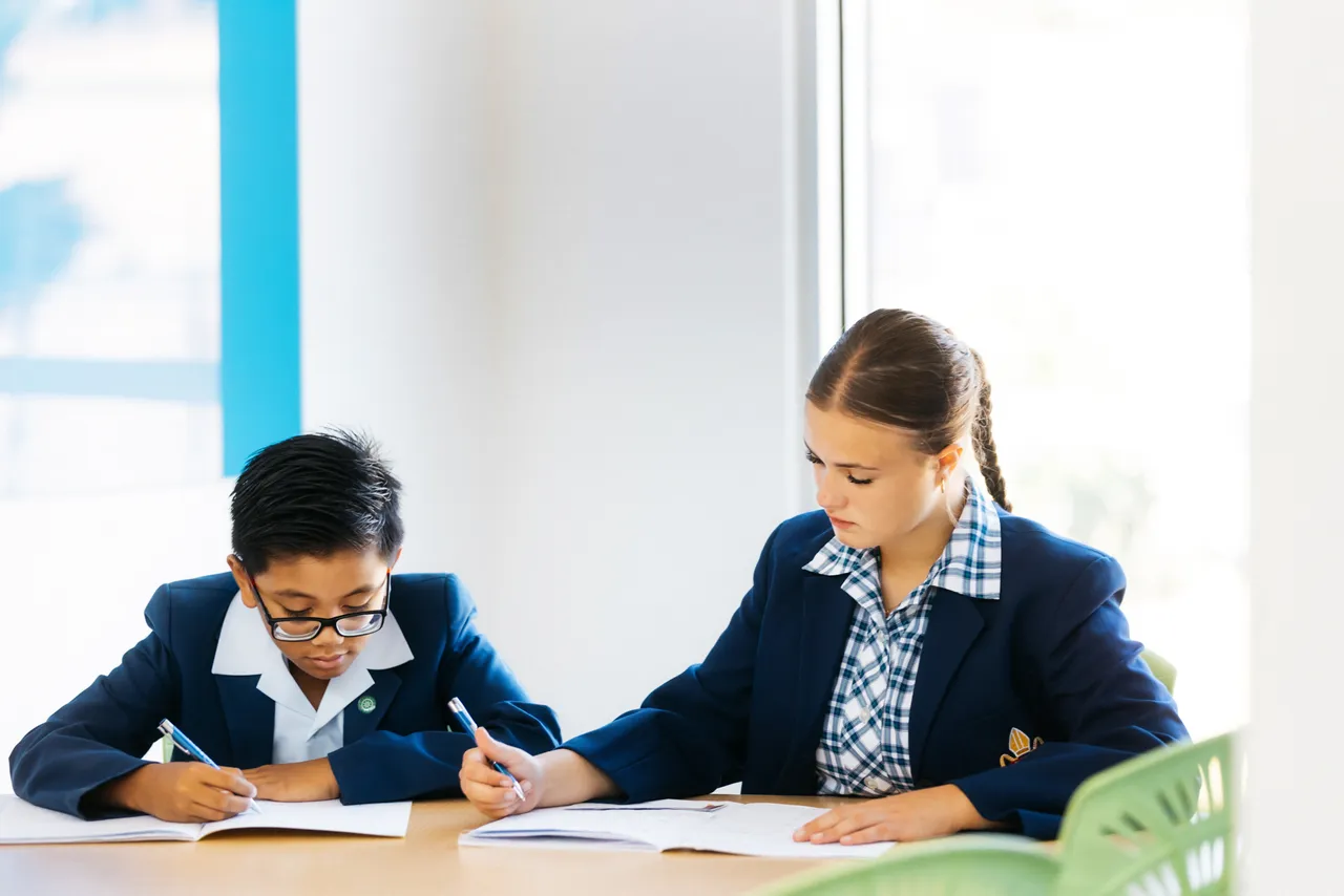 Two upper primary school aged students studying together at a table at Yirramboi Campus