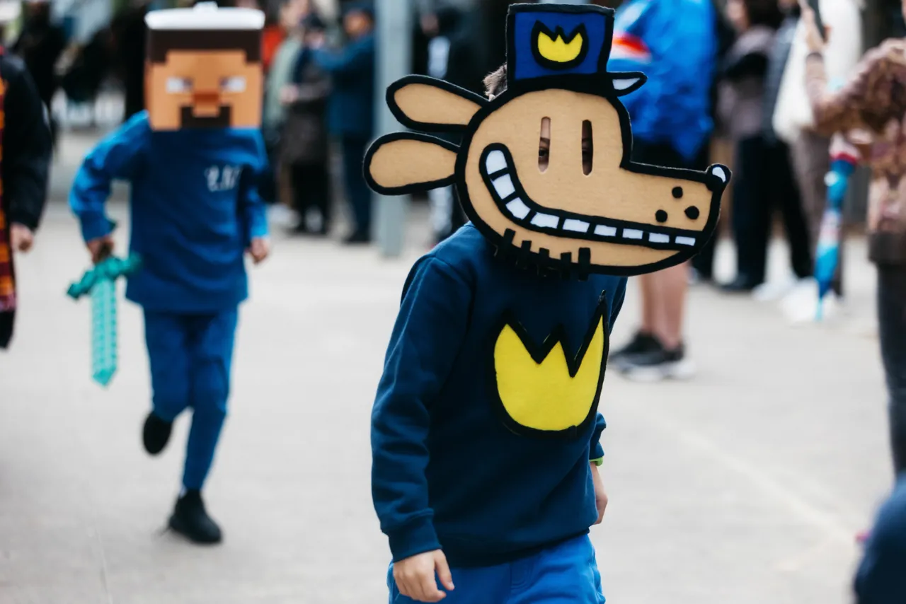 Middle primary school aged student dressed as a beloved storybook character, Dog Man, proudly taking part in Overnewton’s annual Junior School Book Week Parade - a celebration of imagination and the joy of reading.