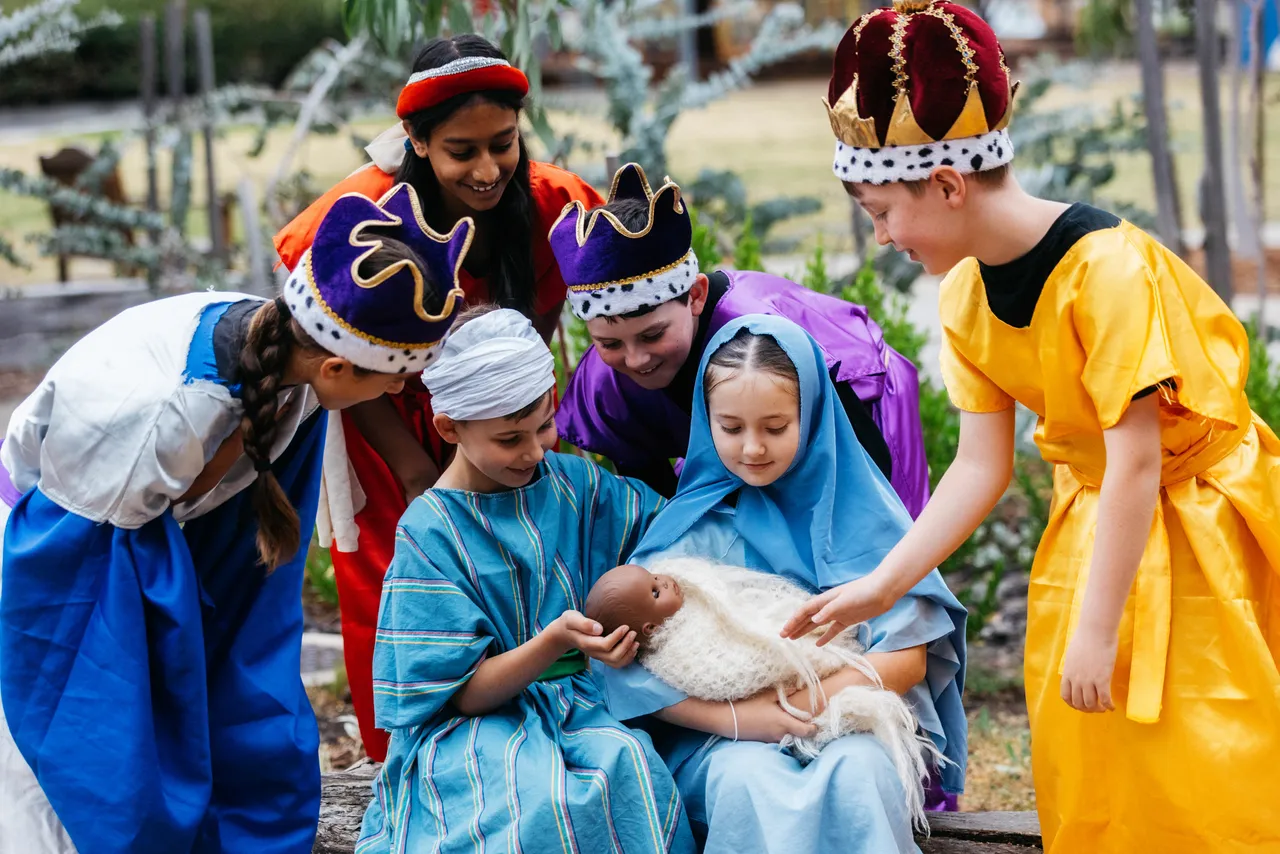 Primary school aged students performing a Nativity scene in the Year 4 Christmas musical at Overnewton, dressed in costume and sharing the story through drama and song.