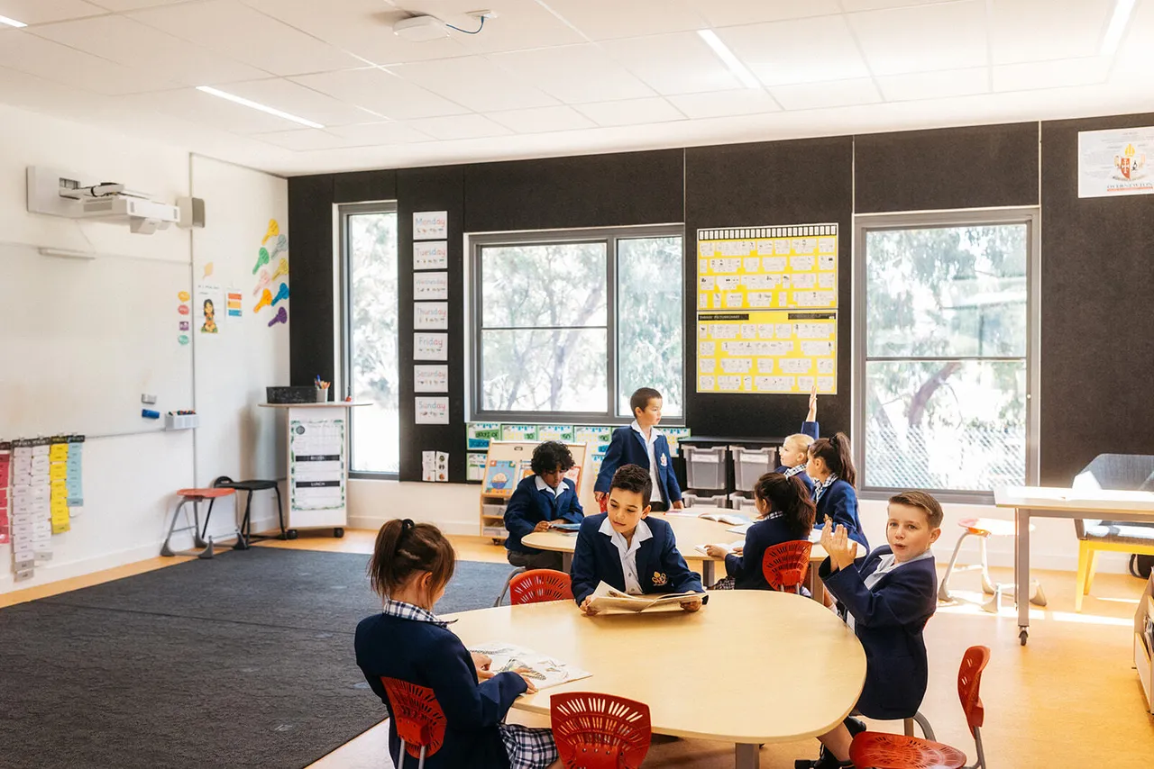 Primary school aged student working at a table inside the Prep to Year 2 building at Canowindra Campus.