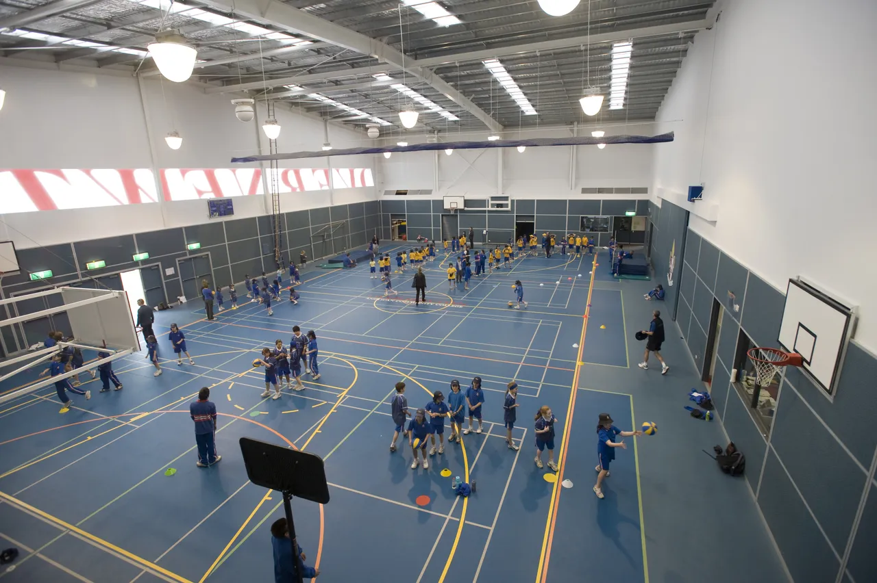Upper primary school aged students using the sports court at Yirramboi Campus for active play, in a space also used by Middle and Senior School students for chapel services and assemblies.