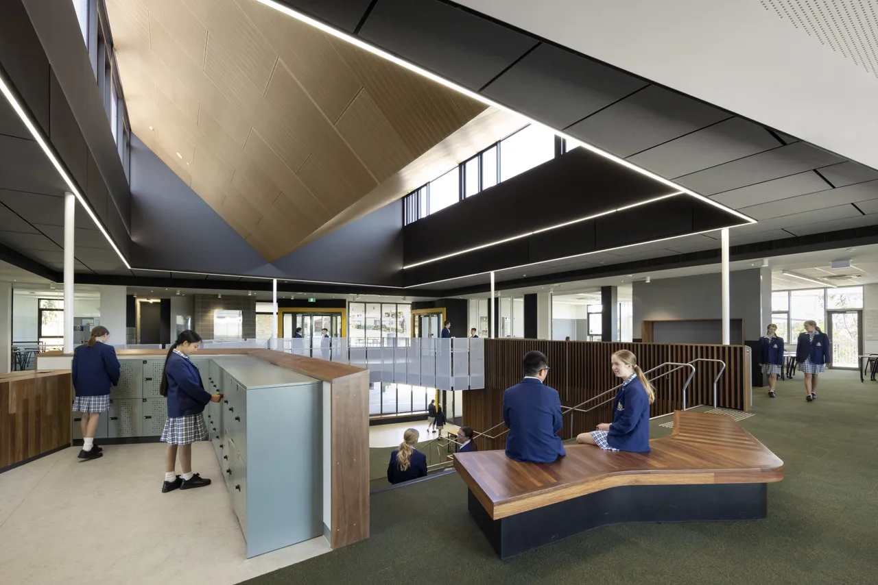 Students gathered in groups and learning through discussion in an open-plan space inside the award-winning Middle School building at Yirramboi Campus—making the most of flexible, collaborative learning areas.