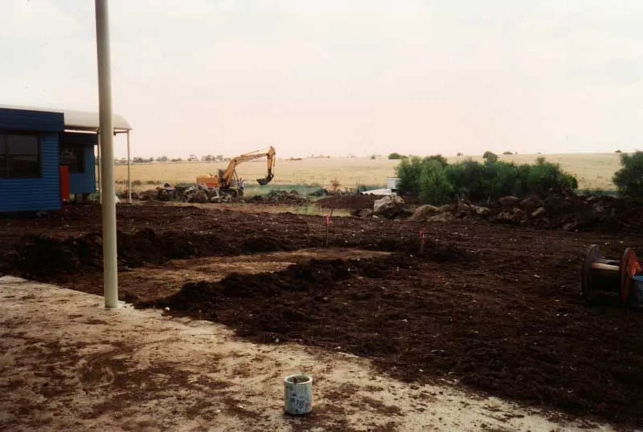 Archival photo from 1995 showing the start of construction at Overnewton’s new Taylors Lakes Campus, with an excavator and dirt piles visible as site preparation begins.