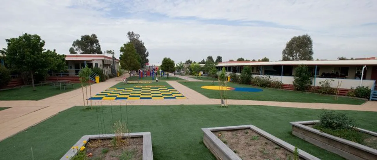 Photo from 2006 showing the new Junior School at Overnewton’s Taylors Lakes Campus, featuring a vibrant play space and newly established garden beds designed for young learners.