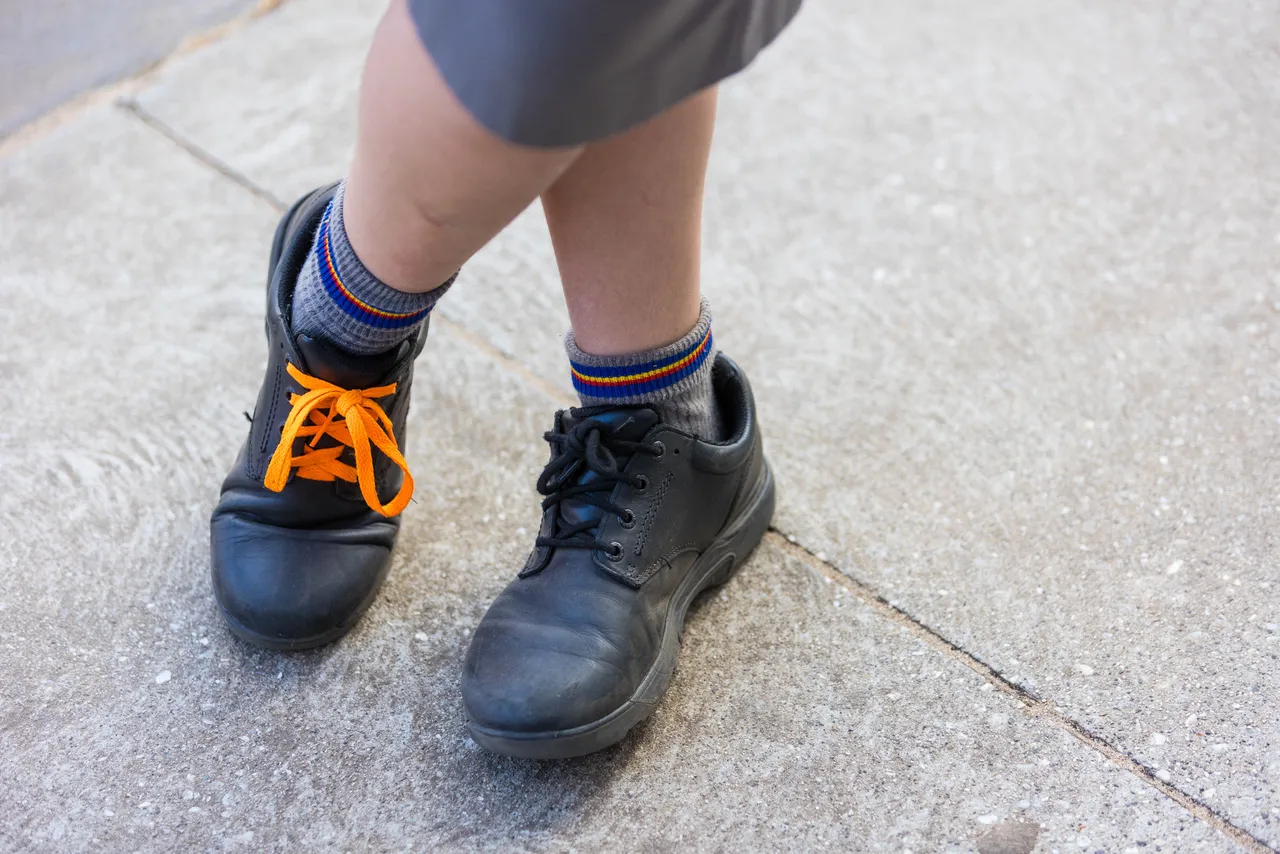 Close-up of Middle School boys’ school shoes with orange laces, worn as a “slash of orange” in support of Harmony Day at Overnewton.