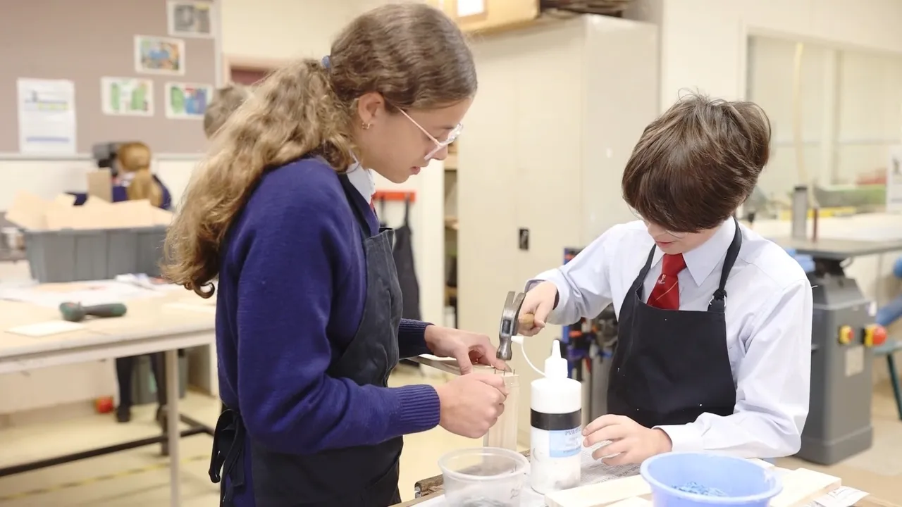 Two upper primary school aged students in the Middle School at Yirramboi Campus engaged in a woodwork activity during Technologies class, working together on their projects.