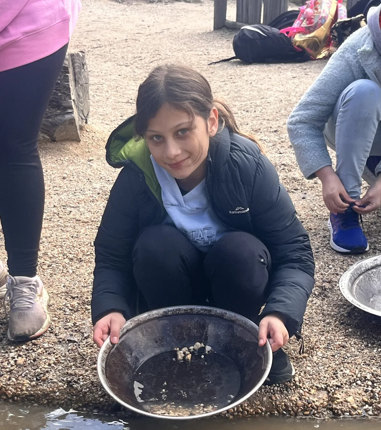 Upper primary school aged student looking directly at the camera, proudly displaying the results of her panning for gold at Sovereign Hill—part of the immersive and hands-on Year 5 Middle School Camp program.