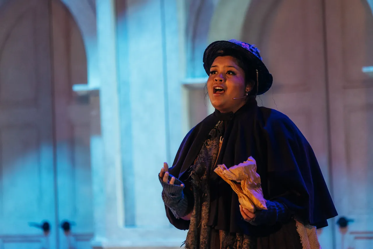 Senior secondary school aged student passionately singing a solo performance to the audience as part of the annual College Musical, Mary Poppins, a key event in Overnewton's Encore Co Curricular program.