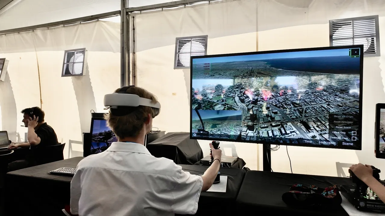 An Overnewton senior secondary school aged VCE Vocational Major student interacting with a computer simulator, part of an interactive Driving Learning educational exhibit at the Melbourne Formula 1 Grand Prix.