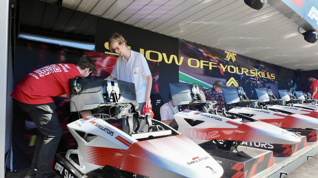 An Overnewton senior secondary school aged VCE Vocational Major student being prepared to engage in a Formula 1 drive simulator, part of an interactive educational exhibit at the Melbourne Formula 1 Grand Prix.