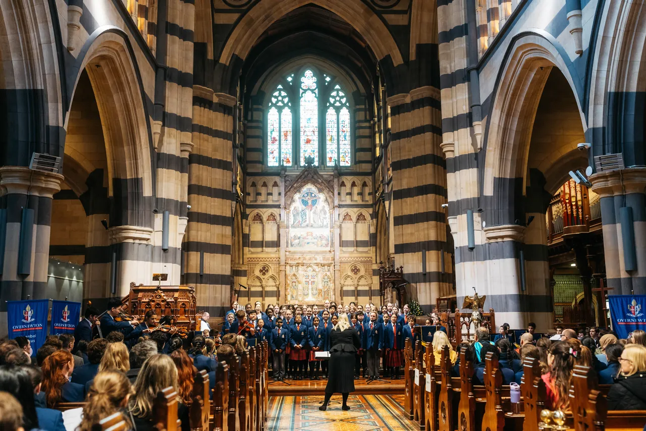 Wide internal shot of St Paul’s Cathedral during the Founders Day Service, featuring the Overnewton choir and musical ensemble performing as part of the service in the grand cathedral setting.