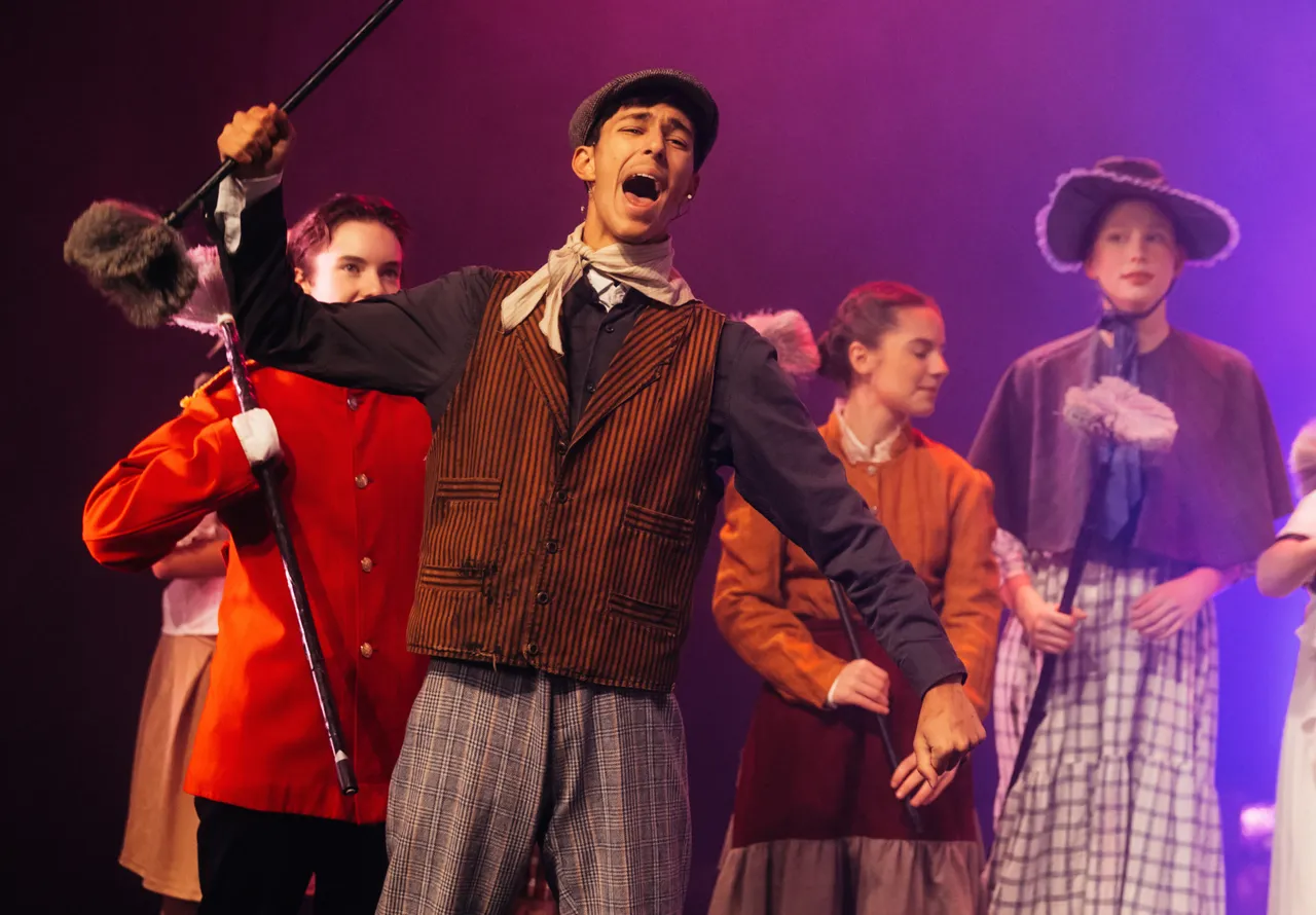 Middle secondary school aged student delivering a passionate performance with chorus during the College Musical, Mary Poppins - a highlight of Overnewton's Encore Performing Arts Co Curricular program.