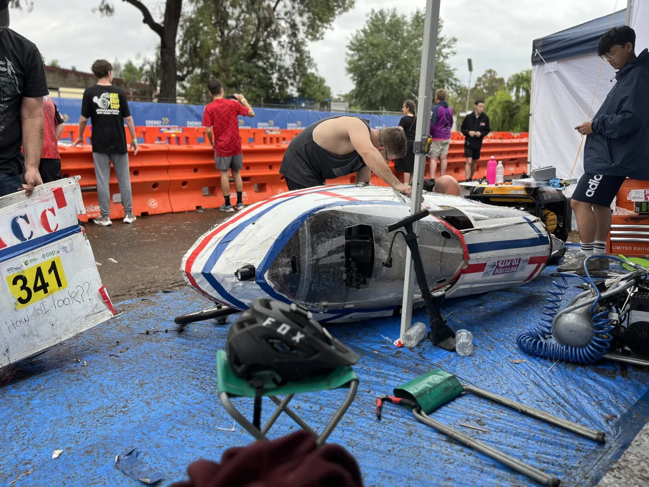 Middle secondary school aged students working on Overnewton’s hand-built Energy Breakthrough vehicle during race time, demonstrating teamwork and problem-solving as part of the immersive Year 9 authentic learning program.