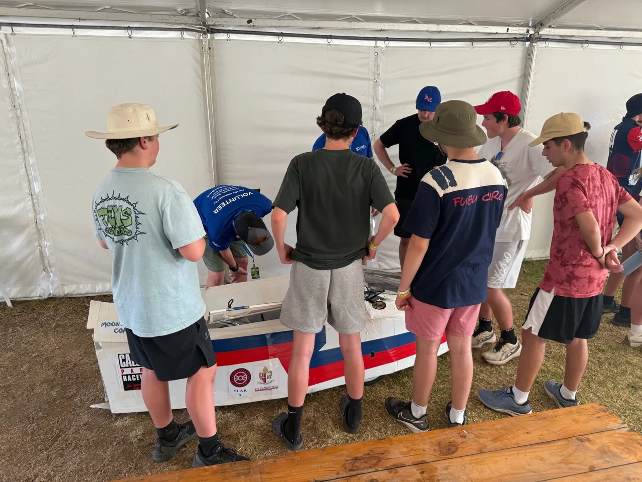 Group of middle secondary school aged students observing works being made to Overnewton’s hand-built Energy Breakthrough vehicle ahead of the race, as part of the immersive Year 9 authentic learning program.