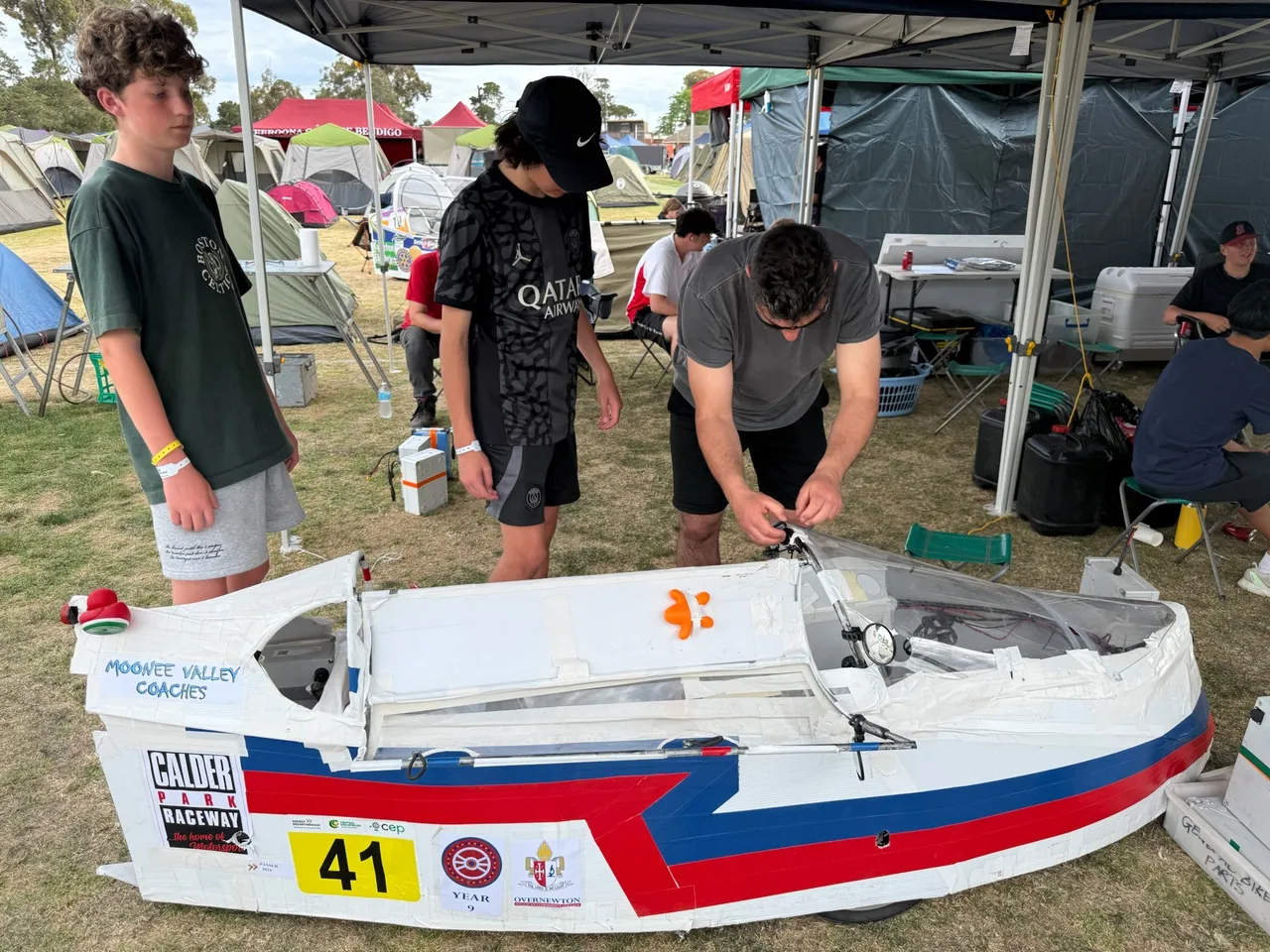 Middle secondary school aged students making final adjustments to Overnewton’s hand-built Energy Breakthrough vehicle ahead of the race, as part of the immersive Year 9 authentic learning program.