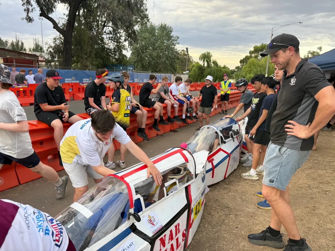 Middle secondary school aged students working on Overnewton’s hand-built Energy Breakthrough vehicle during race time, demonstrating teamwork and problem-solving as part of the immersive Year 9 authentic learning program.