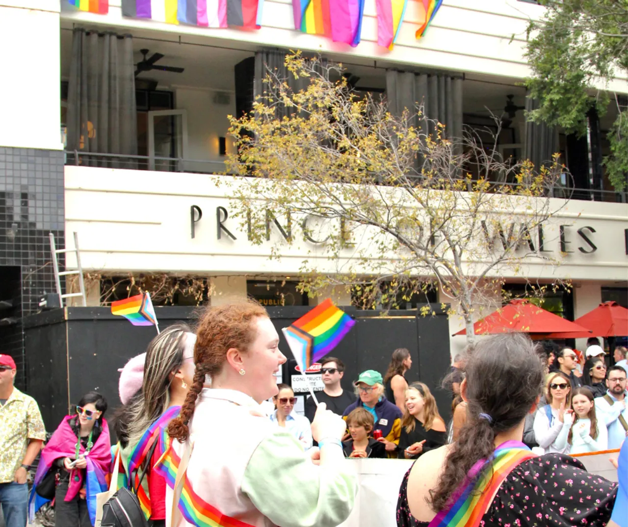 A group of upper secondary school aged students and staff representing Overnewton Anglican Community College at the 2026 Midsumma Pride March.  Students can be seen walking in front of the iconic facade of the Prince of Wales Hotel in St Kilda.