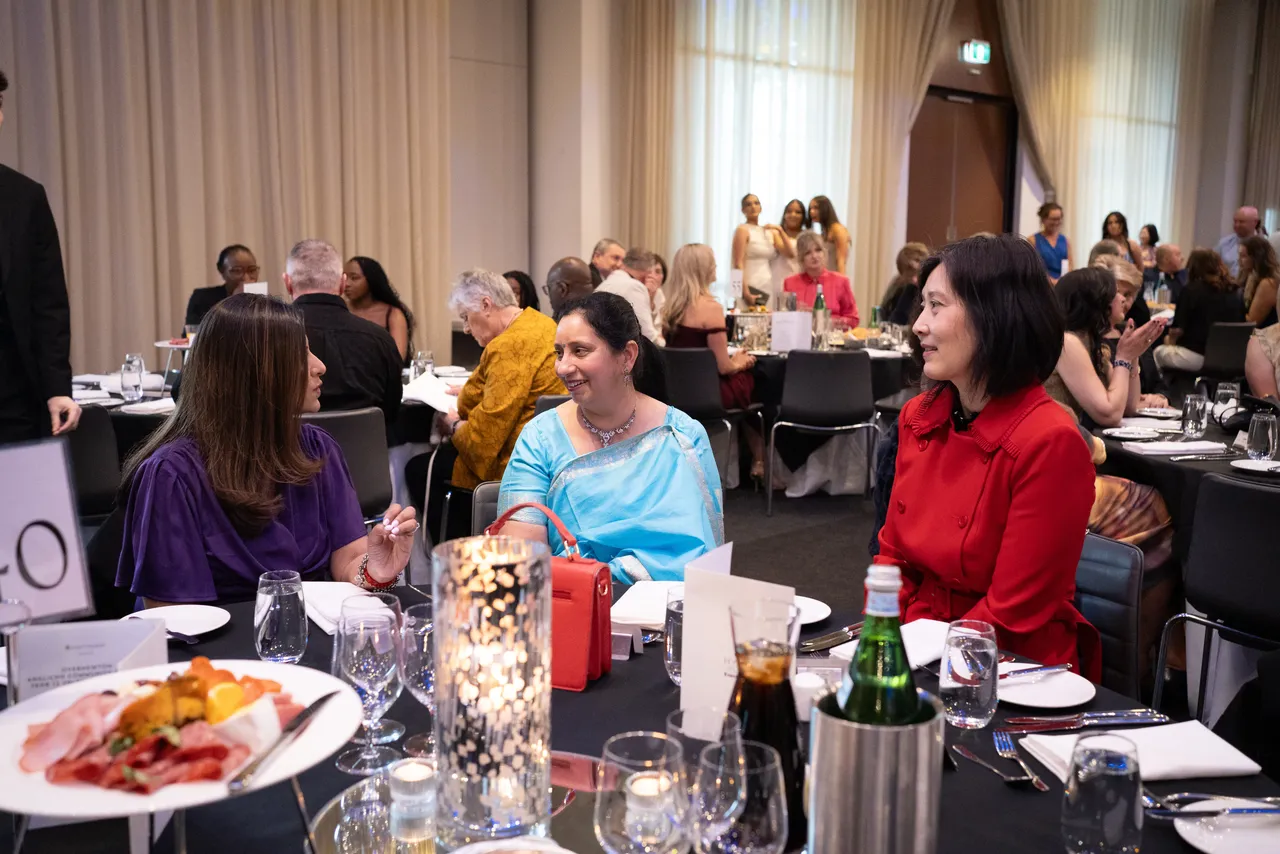 Parents of students from the Overnewton Class of 2025, sitting chatting at their dining table during the Year 12 Valedictory Dinner event held at Hyatt Place, Essendon Fields.